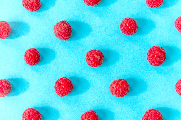 istock Colorful pattern of raspberries on blue background. Top view. Flat lay, pattern 1167402596