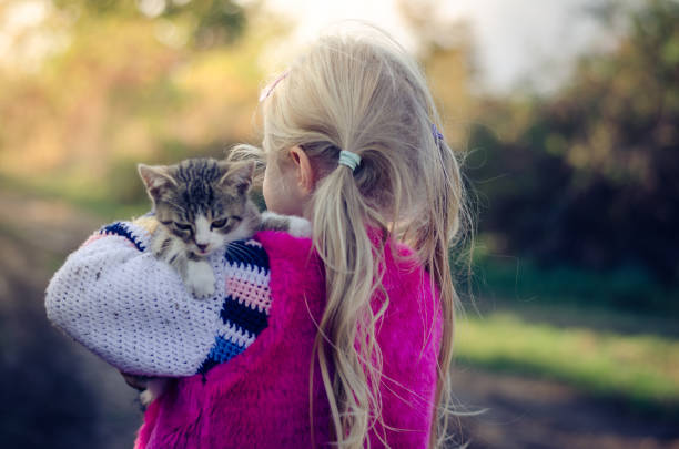 istock child cuddling little pet cat 1167403490