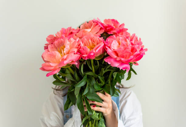 istock Girl with pink peonies 1167403626