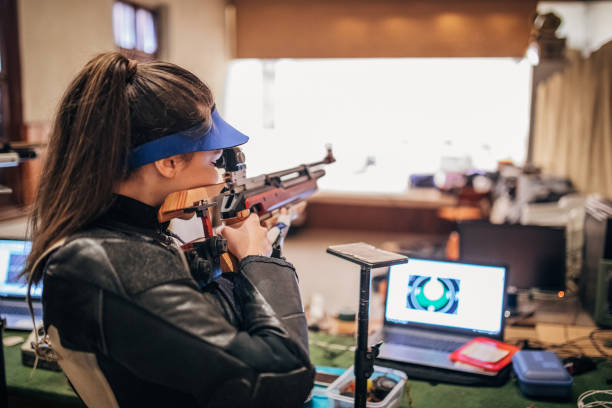 istock Girl with a machine gun practice target shooting 1167405508