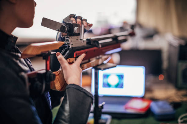 istock Girl with a machine gun practice target shooting 1167405600