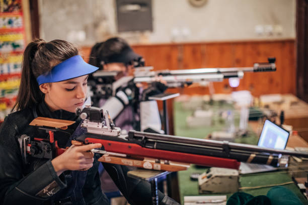 istock Girls with a machine gun practice target shooting 1167405707