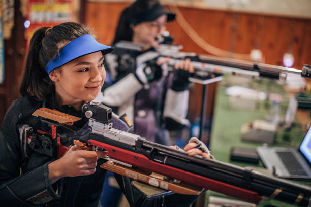 istock Girls with a machine gun practice target shooting 1167405762