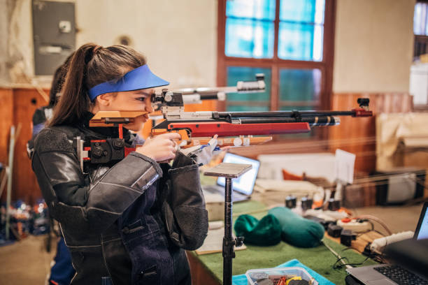 istock Girls with a machine gun practice target shooting 1167405895