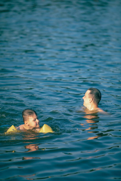 istock father with kid having fun in water swimming together 1167406505