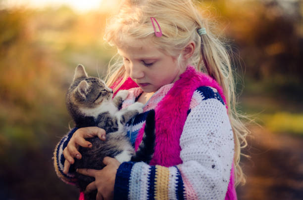 istock child cuddling little pet cat 1167406734