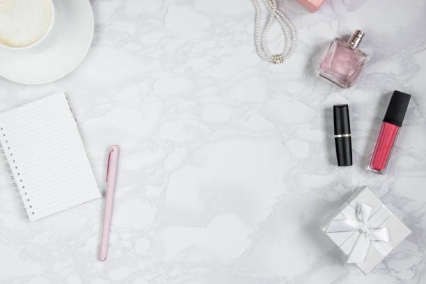 istock Pink pen, notebook, perfume, gift box, pearls, a glass of coffee. Layout for adding tags. Top view, flat lay, copy space 1167408084