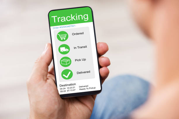 istock Man's Hand Holding Cell Phone With Blank Screen 1167409973