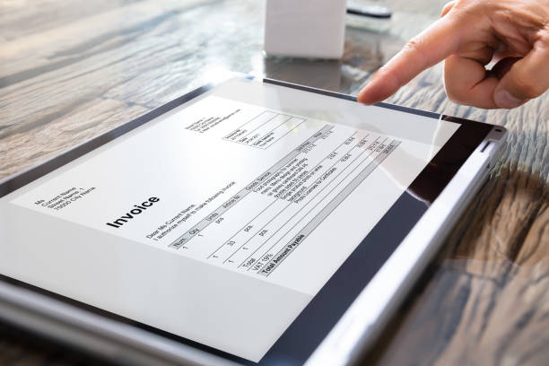 istock Businessman's Hands Working On Invoice On Convertible Laptop 1167410583