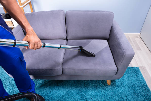 istock Man Cleaning Sofa With Vacuum Cleaner 1167411737
