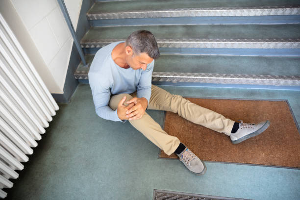 hombre maduro sentado en la escalera - fell down fotografías e imágenes de stock