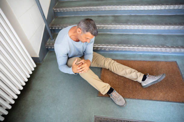 Mature Man Sitting On Staircase Mature Man Sitting On Staircase After Slip And Fall Accident drop stock pictures, royalty-free photos & images