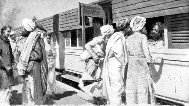 People boarding the first class section of a train in Jodhpur, India during the British Raj era (circa late 19th century). Vintage etching circa late 19th century.