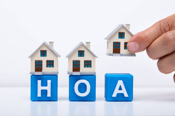 istock Businessman Placing House Models On HOA Cubic Blocks 1167413570