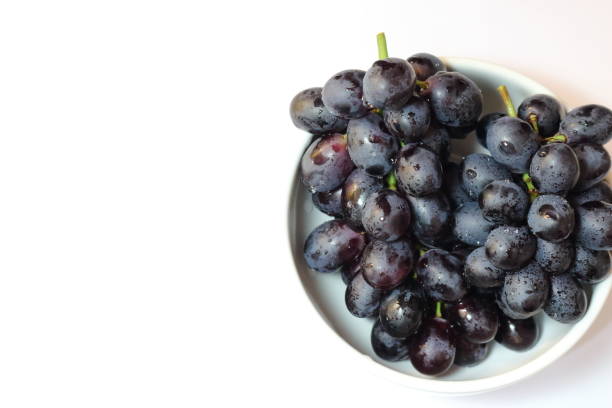 istock Bunch of grapes on white background. Space to insert text. 1167413699