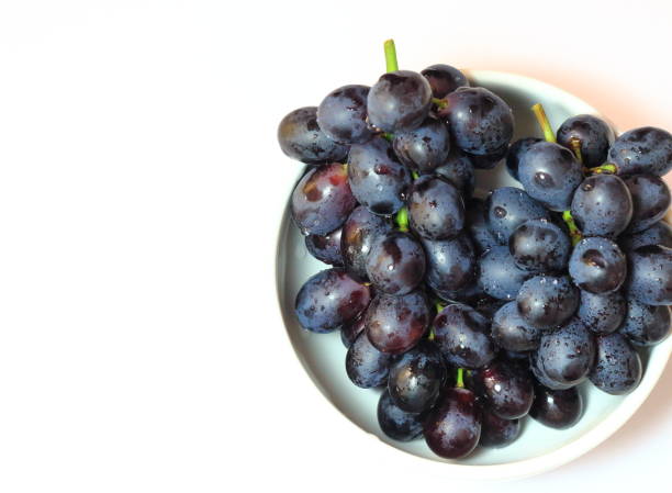 istock Bunch of grapes on white background. Space to insert text. 1167414150