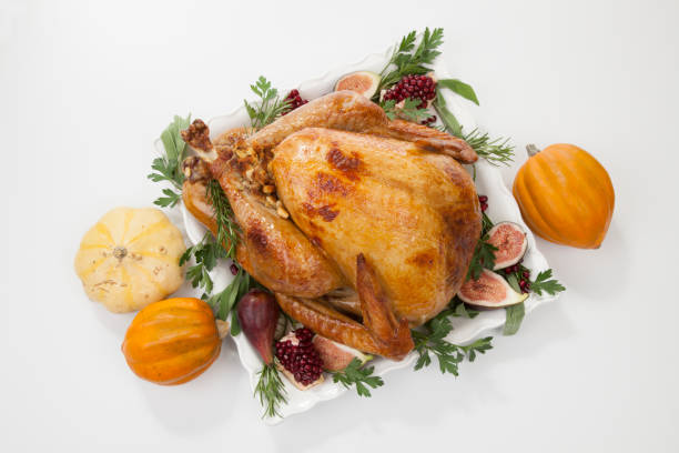 istock Traditional Roasted Turkey on White With Pumpkin 1167414440