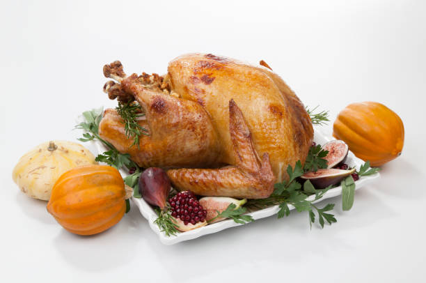 istock Traditional Roasted Turkey on White With Pumpkin 1167414442