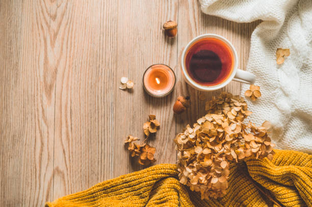 istock Background with warm sweaters and cup tea. Cozy still life in warm shades, space for text, Autumn winter concept. 1167414716