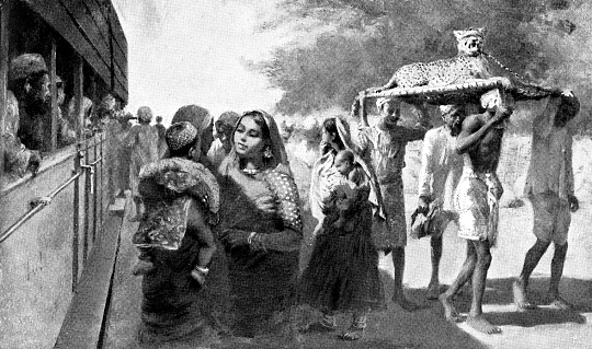 People boarding the third class section of a train in Jodhpur, India during the British Raj era (circa late 19th century). Vintage etching circa late 19th century.