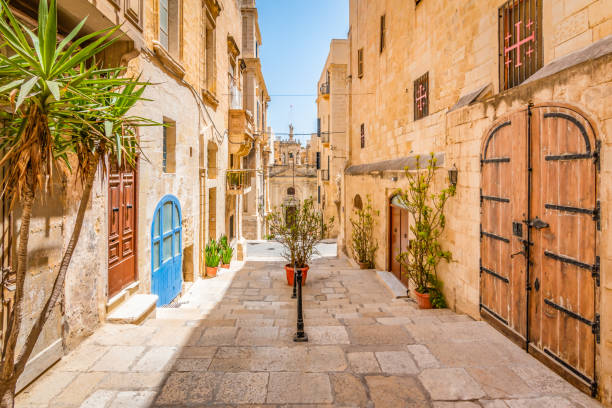 Narrow street in city centre of Valletta, Malta. Bright and colorful image of typical narrow street in Valletta. Beautiful summer vacation day in Malta, Europe. valletta photos stock pictures, royalty-free photos & images