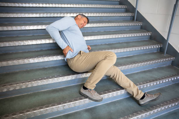 Mature Man Lying On Staircase Mature Man Lying On Staircase After Slip And Fall Accident slippery stock pictures, royalty-free photos & images