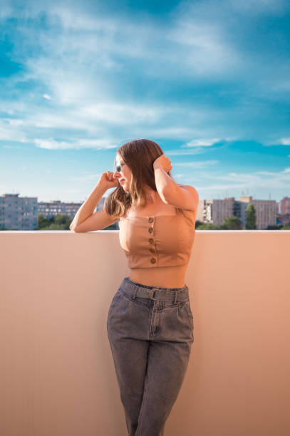istock Woman, beige top, sunglasses, jeans 1167417774
