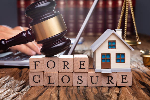 istock Judge Holding Gavel On House At Desk 1167417803