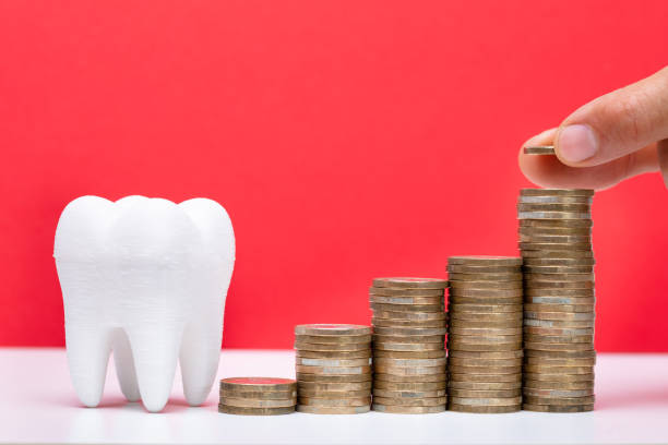 istock Stack Of Coins In Front Of Healthy Tooth 1167417820