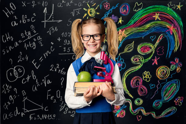istock Child Learning Creativity and Mathematics, Creative School Girl Student on Blackboard 1167418871
