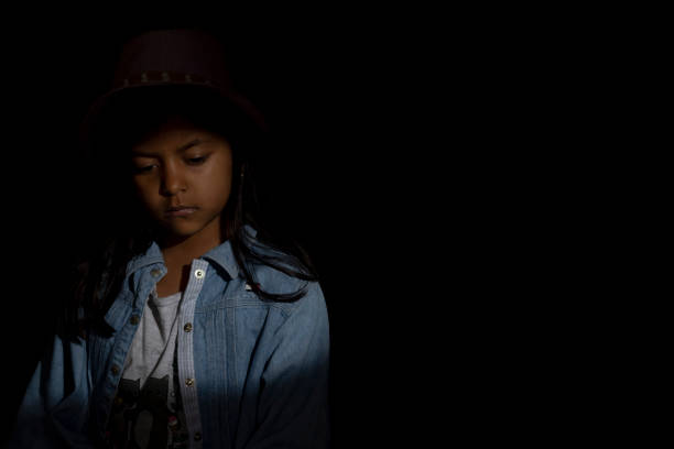 Cute girl illuminated between lights and shadows