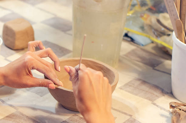 istock Girl sculpts from clay. Creating dishes with 1167420738