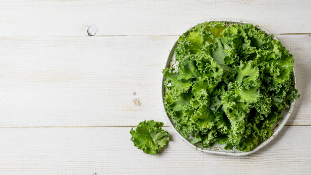 istock Kale leaves in bowl, copy space, top view 1167421284