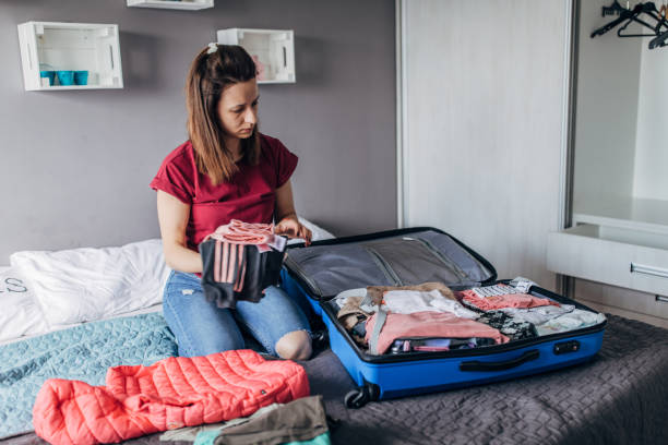 istock Woman packing clothes in suitcase 1167423240
