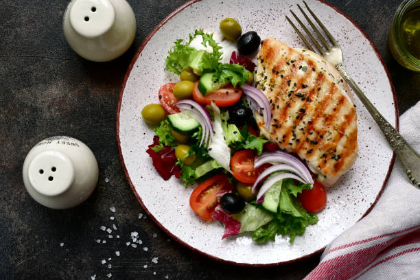 istock Grilled chicken or turkey breast with fresh vegetable salad 1167423381