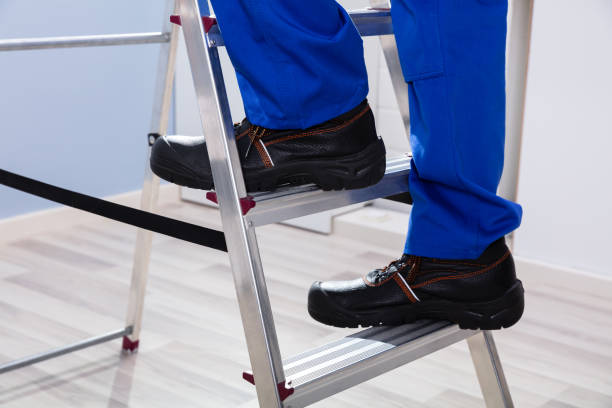 istock Handyman Climbing Ladder 1167429210