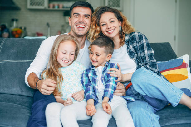 istock Happy parents with children at home 1167429604