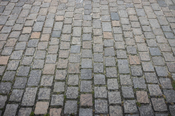 istock Old road paved with granite stones 1167430245