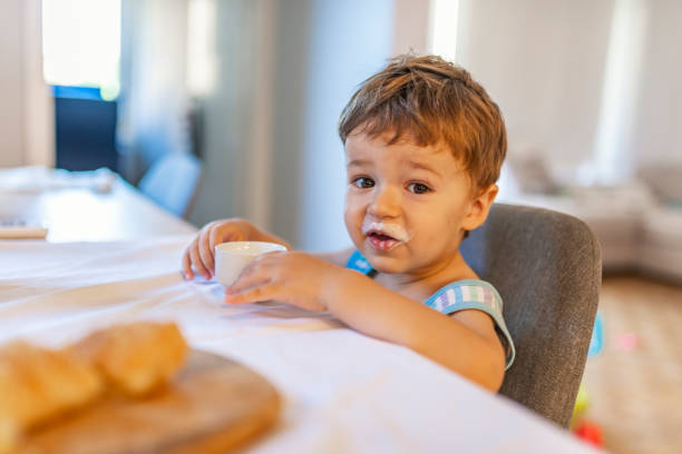 istock Blonde happy boy eating at table 1167430325
