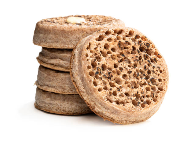 istock Stack of wholemeal crumpets isolated on white background 1167430497
