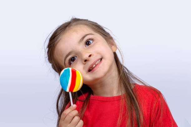 istock Little girl eating a lollipop. 1167430713
