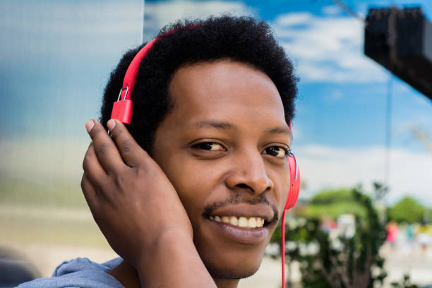 istock Young man enjoying music outdoor. 1167430724