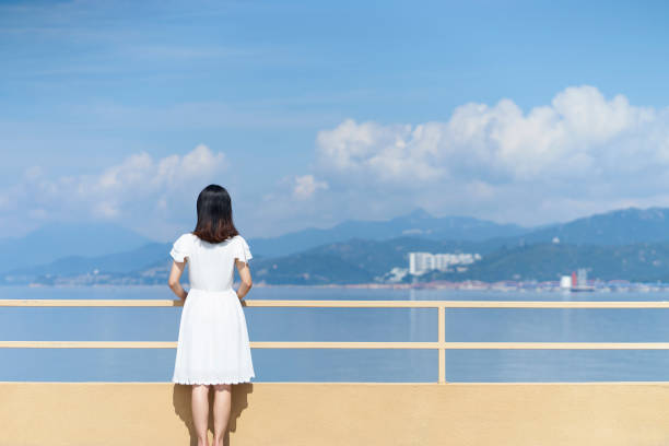 istock young woman looking at sea 1167431564