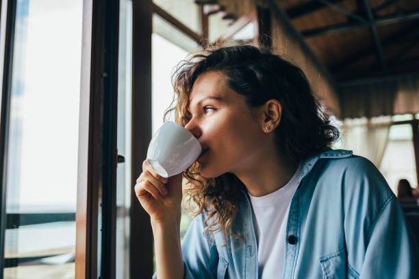 istock Young woman with long curly hair 1167431718