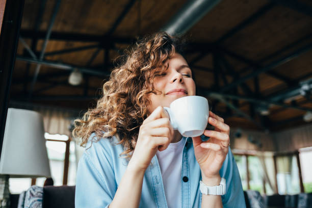 istock Beautiful young woman smiling closing her eyes 1167431755