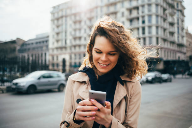 istock Laughing young woman wearing beige coat 1167431858