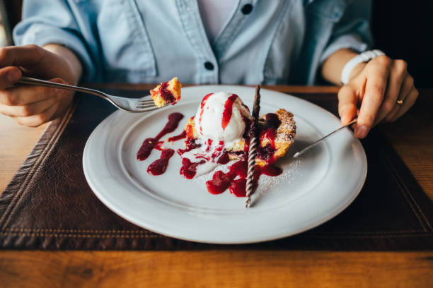 istock Young woman eating dessert in restaurant 1167431868