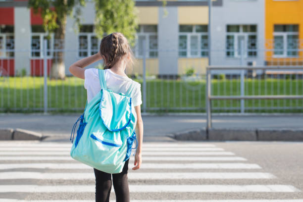 istock Back to school education concept with girl kids, elementary students, carrying backpacks going to class 1167432257