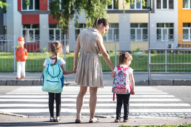 istock Back to school education concept with girl kids, elementary students, carrying backpacks going to class 1167432277