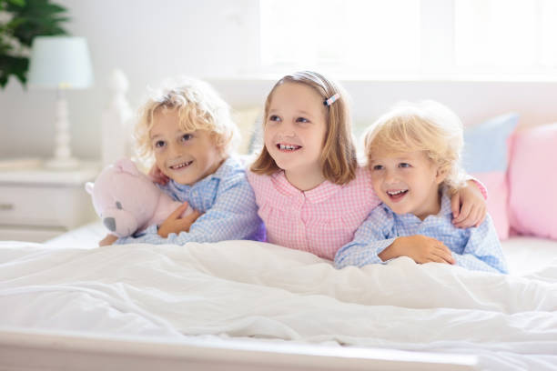 istock Kids play in bed. Children at home. 1167433129